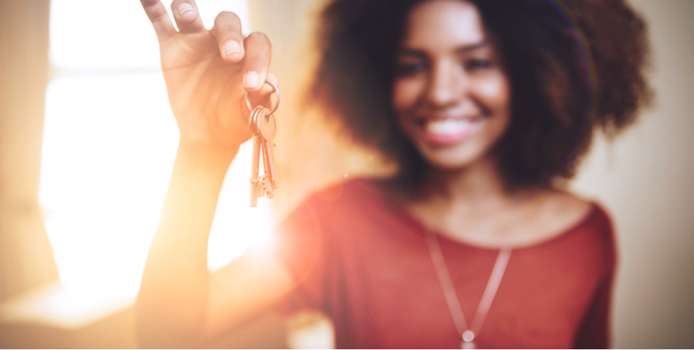 A women holding up a set of keys.